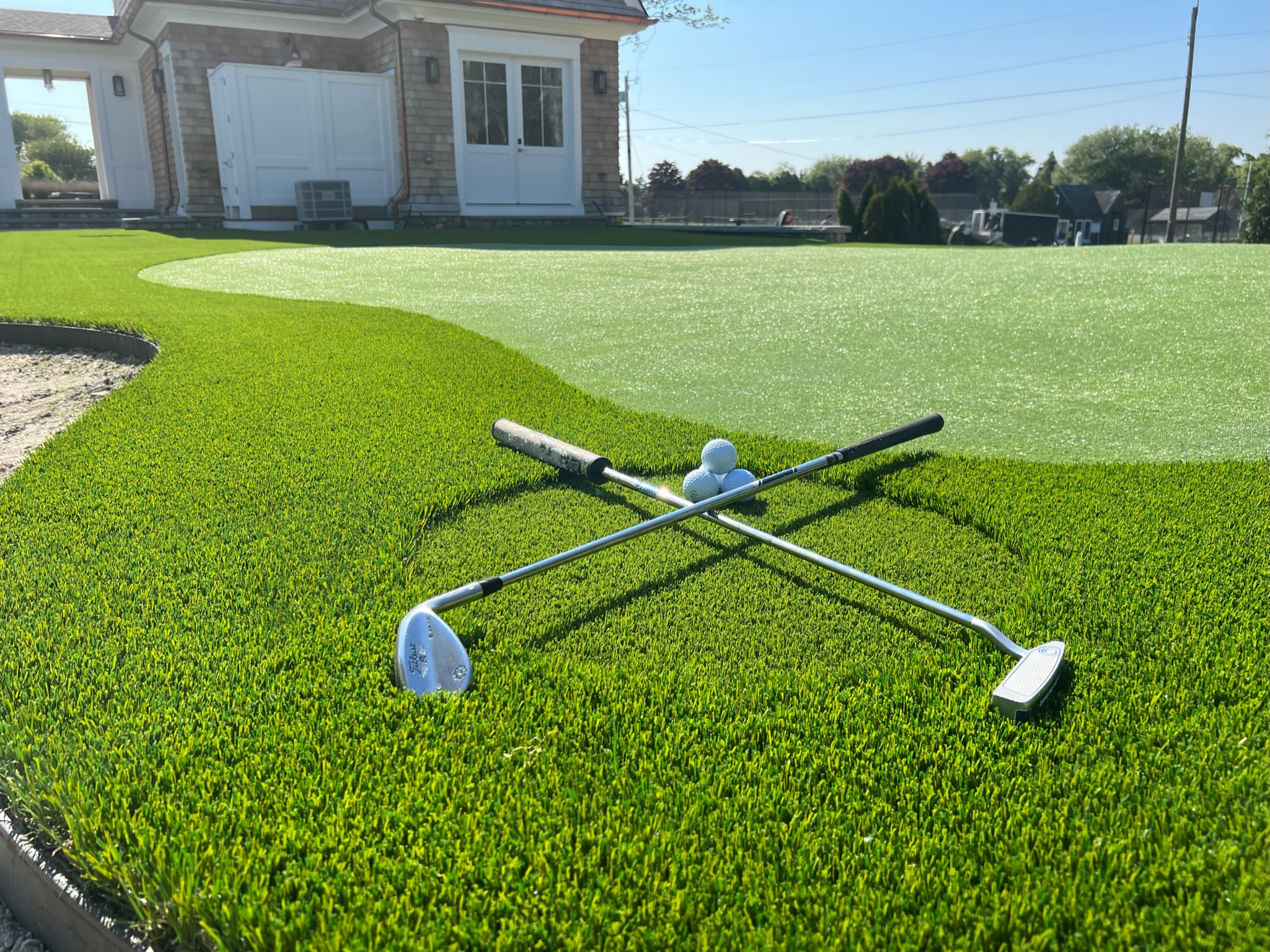Golf clubs on freshly installed putting green