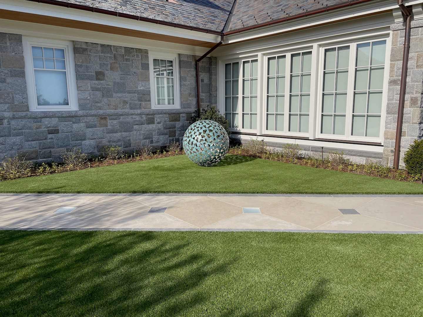 Synthetic lawn with landscaping