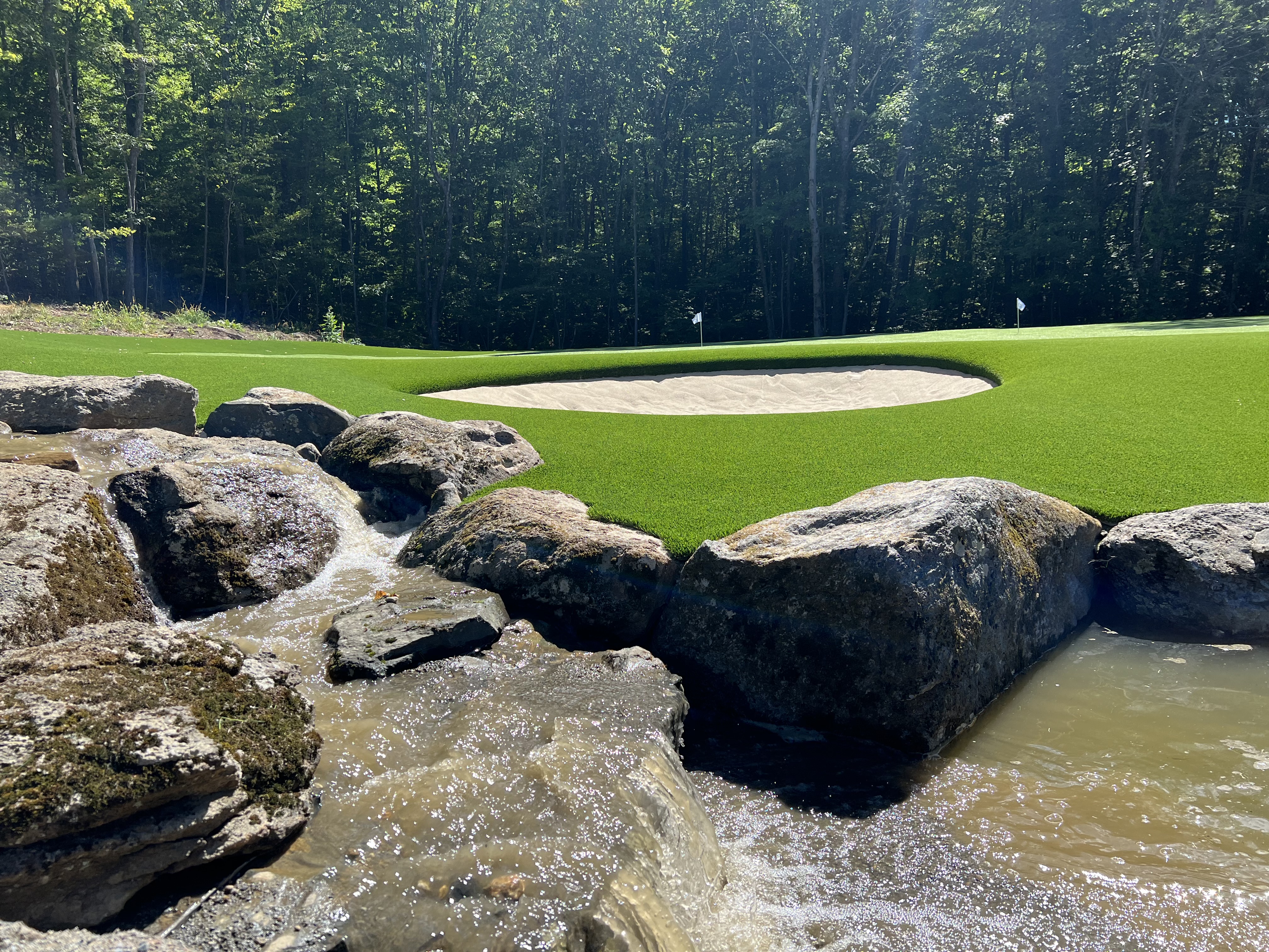 Private putting green with rock-and-water feature