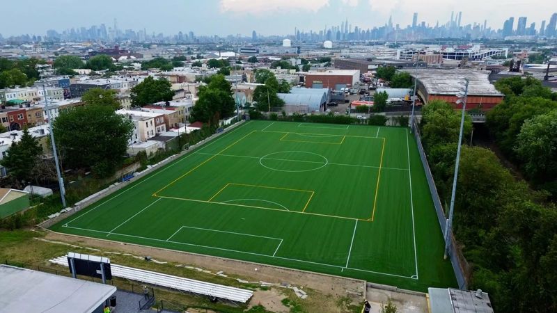 Aerial view of a complete synthetic soccer field, goals and markings in an urban setting