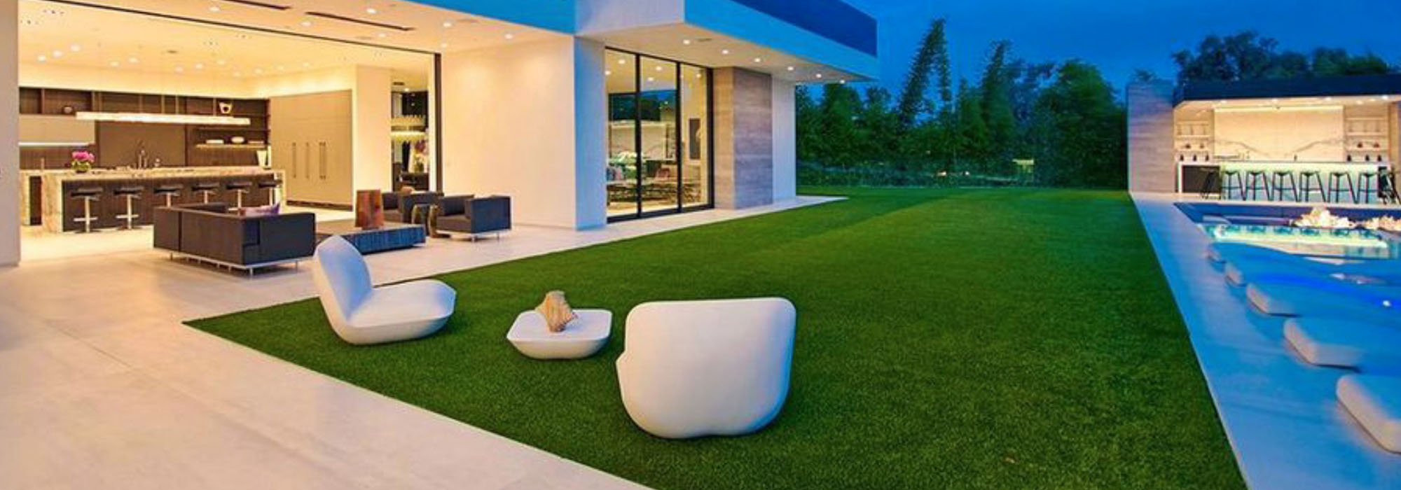 contemporary home with synthetic grass backyard