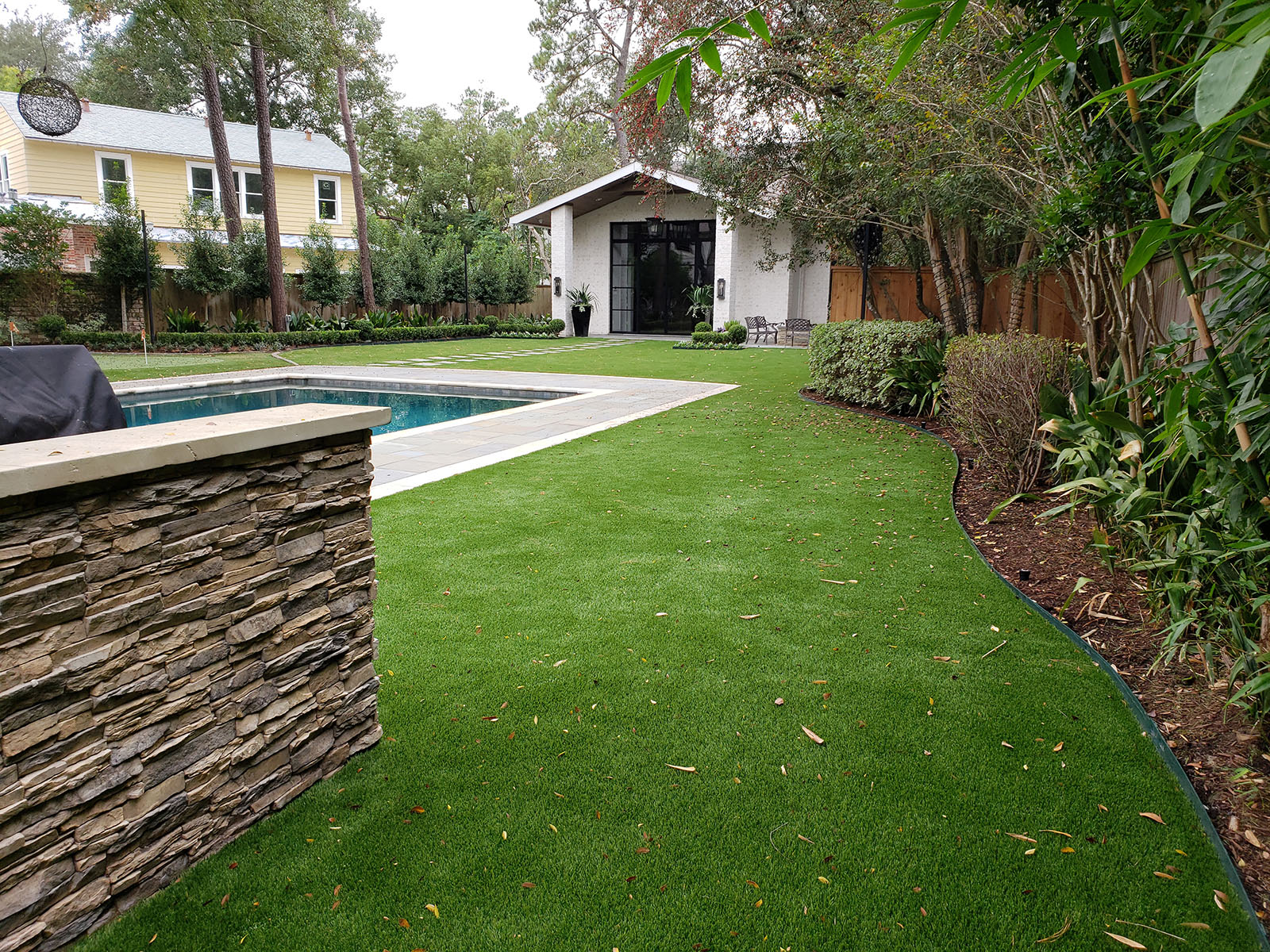 private backyard with synthetic turf lawn